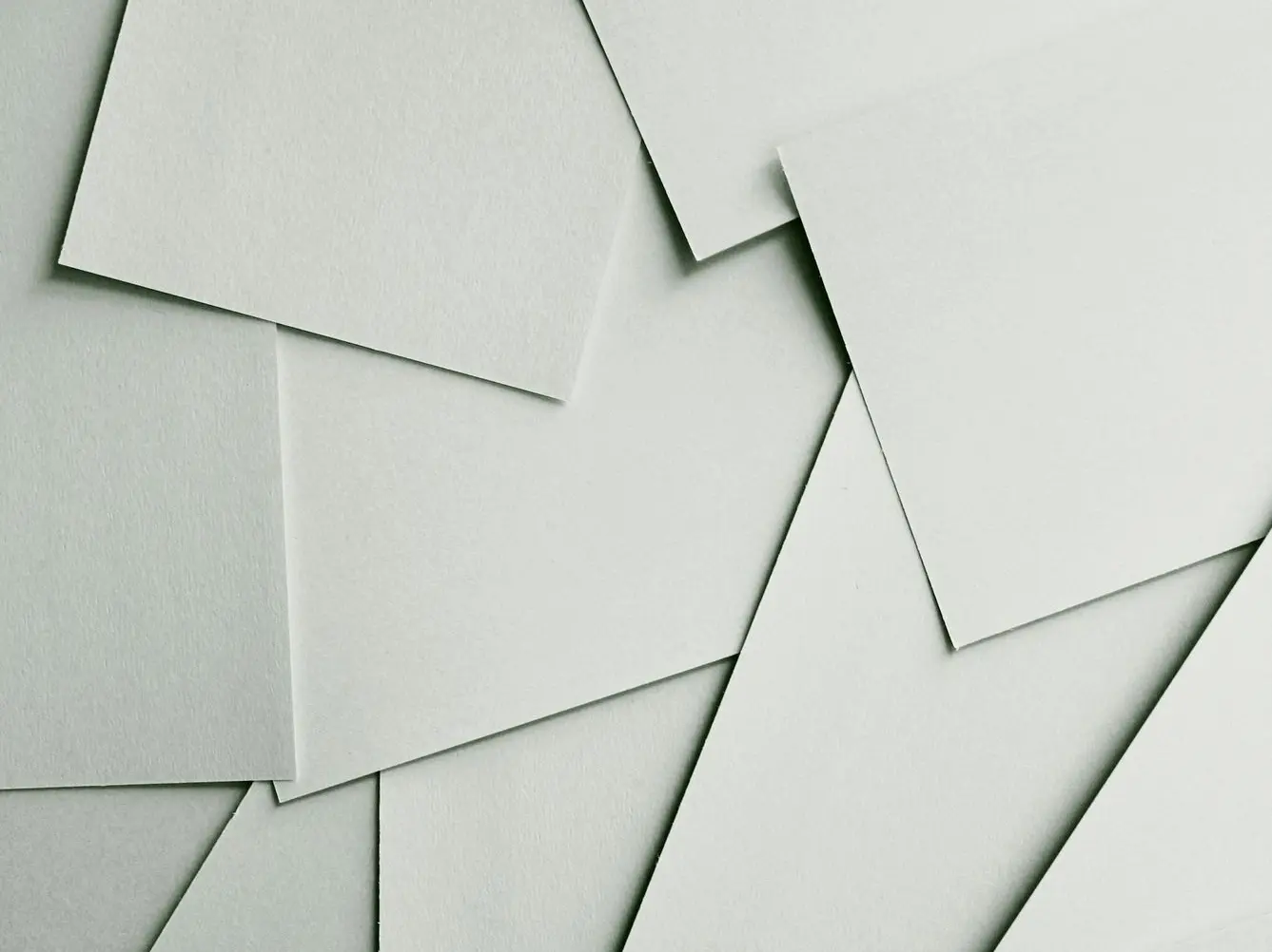 Scattered sheets of white paper covering the entire frame